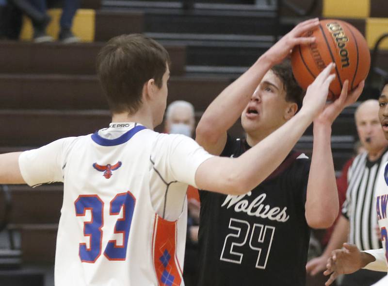 Prairie Ridge's Ben Gablenz charges into Hoffman Estates’ Abell Bosnjak as he drives to the basket during a Hinkle Holiday Classic basketball game Wednesday, Dec. 28, 2022, at Jacobs High School in Algonquin.