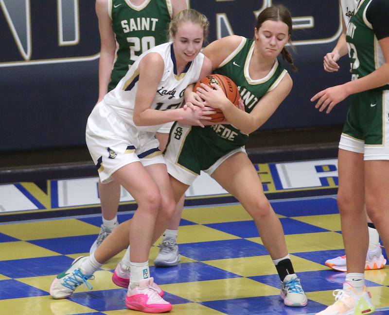 Marquette's Lilly Craig forces a jump ball with St. Bede's Ella Hermes on Monday, Nov. 27, 2023 in Bader Gym at Marquette High School.