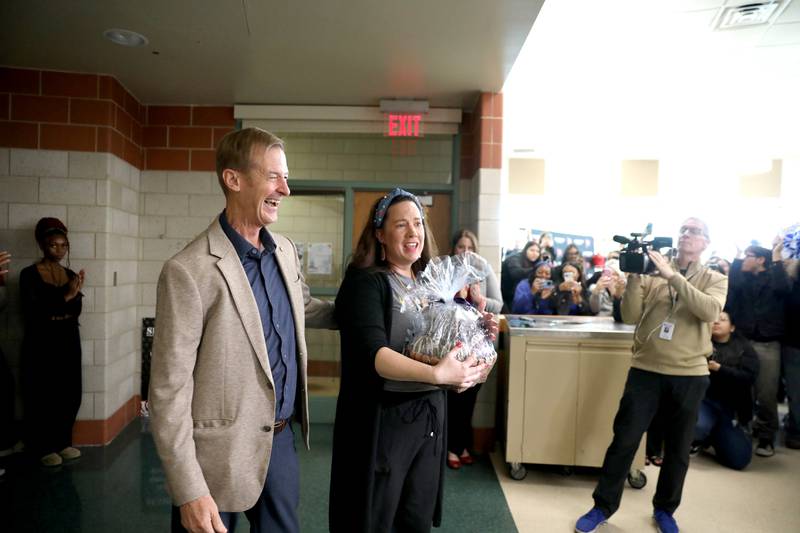 Bolingbrook High School teacher Erin Clifford, with Golden Apple Foundation President Alan Mather, was surprised by her family, colleagues, students and Golden Apple Foundation officials on Tuesday, May 6, 2025 as it was announced she had won a Golden Apple Award for Excellence in Teaching.