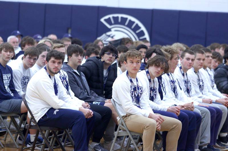 Players listen to Head Coach Brad Seaburg speak during a celebration of the IHSA Class 6A Champion Cary-Grove football team at the high school Sunday.