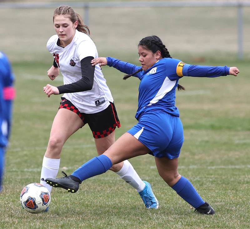 Hinckley-Big Rock-Somonauk’s Melissa Magro tries to kick the ball by Indian Creek's Audrey Witte during their game Monday, April 3, 2023, at Hinckley-Big Rock High School.