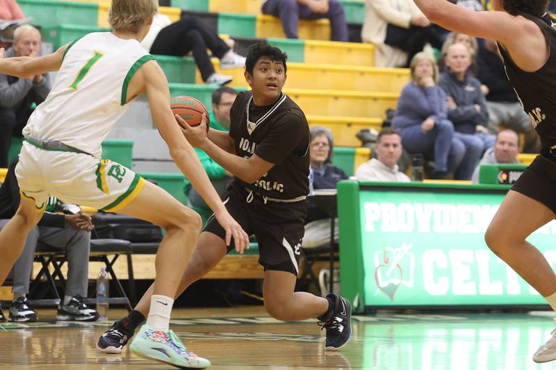 Joliet Catholic’s James Pilapil looks to pass against Providence on Saturday, Dec. 9th, 2023 in New Lenox.