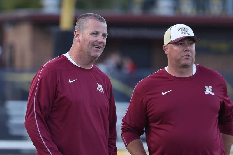 Morris head coach Alan Thorson, left, talks to one of his coaches before the start of the game against Joliet West on Friday, Sept. 6, 2024 in Joliet.