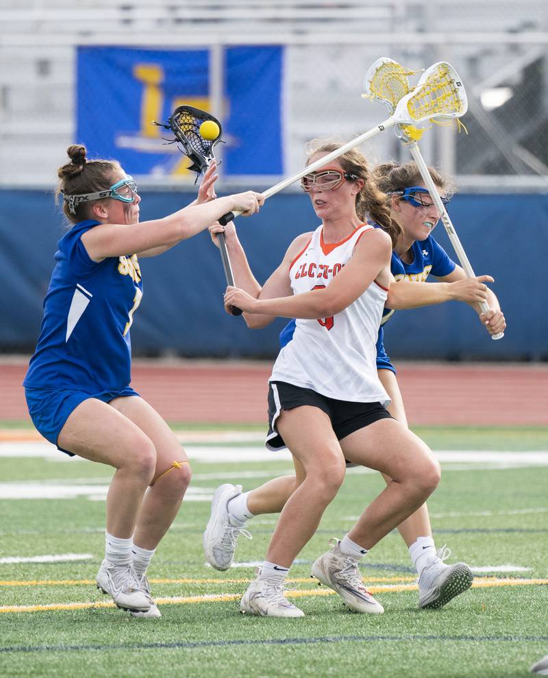 Crystal Lake Central Co-Op's Fiona Lemke battles with Lake Forest's Lissy Blume, left, and Caroline Keil during the girls lacrosse supersectional match on Tuesday, May 31, 2022 at Hoffman Estates High School.