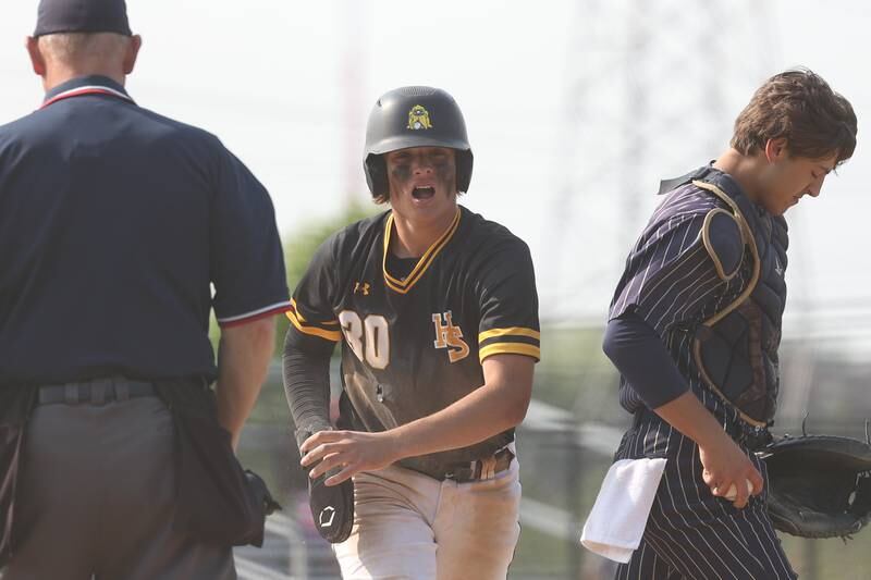 Hinsdale South’s Andrew Miller celebrates after stealing home against Lemont on Wednesday, May 24, 2023, in Lemont.