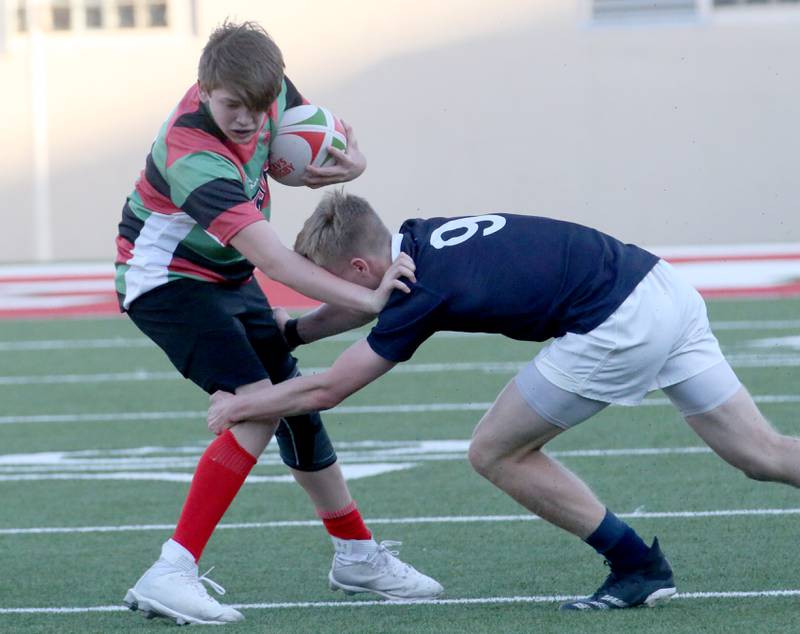 La Salle-Peru's Thomas Schroeder runs with the ball as he is tackled by La Salette Academy's Eric Terzick during a rugby game on Wednesday, April 12, 2023 at Howard Fellows Stadium at L-P High School.
