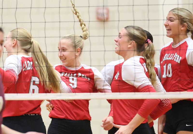 Members of the L-P volleyball team react after scoring a point against Morris during the Class 3A Sectional semifinal game on Tuesday, Nov. 4, 2025 in Sellett Gymnasium at L-P High School.