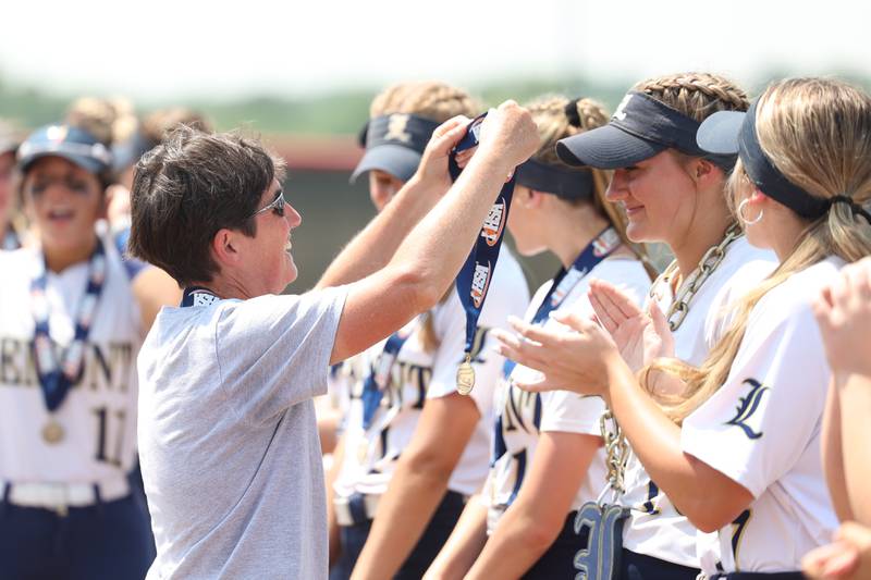 Lemont head coach Chris Traina gives Sage Mardjetko her 1st place medal after the 1-0 win against Antioch in the Class 3A state championship game on Saturday, June 10, 2023 in Peoria.