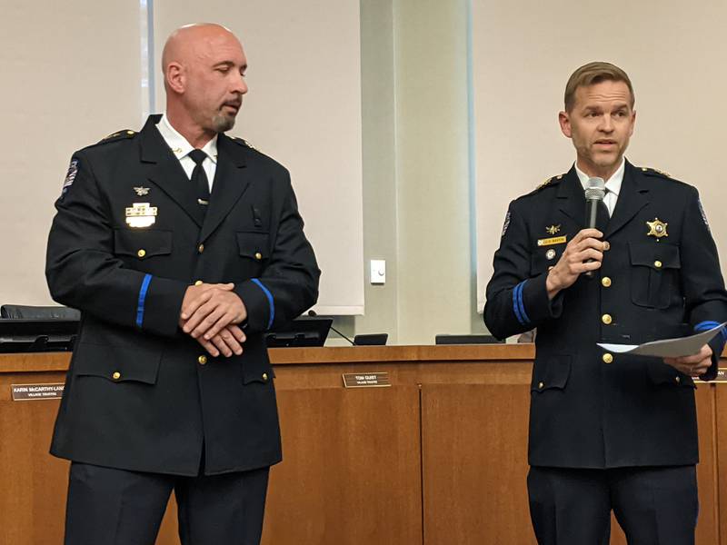Oswego interim police chief Jason Bastin, right, introduces new Oswego deputy police chief of field operations, left, during the June 27 Oswego Village Board meeting.