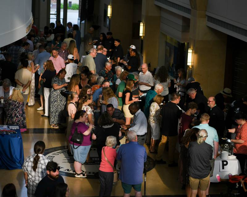 Community members sample food during the 21st annual CASA DeKalb County's Men Who Cook fundraiser held at Northern Illinois University's Barsema Alumni and Visitors Center.