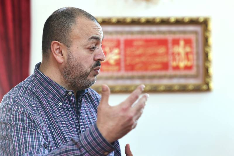 Mohammed Labadi, president of the Islamic Center of DeKalb, talks in front of a picture that  depicts one of the most important chapters of the Koran Friday, April 7, 2023, at the center, as he explains Ramadan, how it is observed, the traditions involved, and what the Islamic community would want others to know about the Muslim holy month.