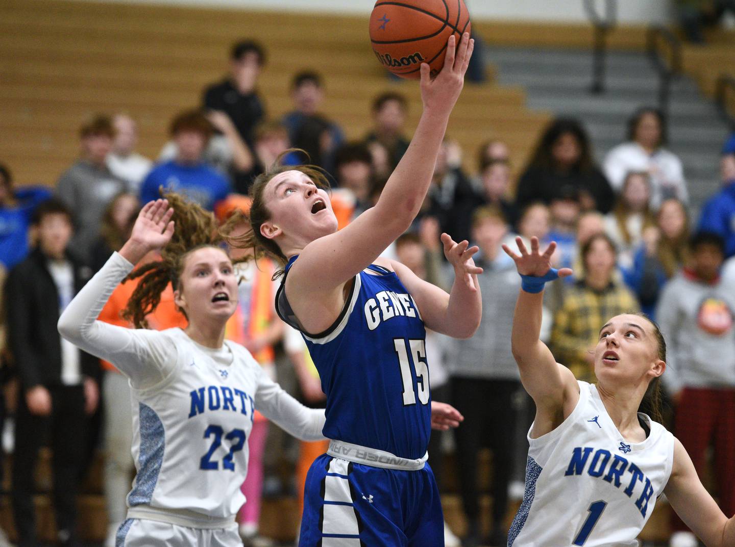 Geneva's Cassidy Arni (15) takes a shot between St. Charles North's Katrina Stack (22) and Laney Stark during Thursday’s girls basketball game in St. Charles.