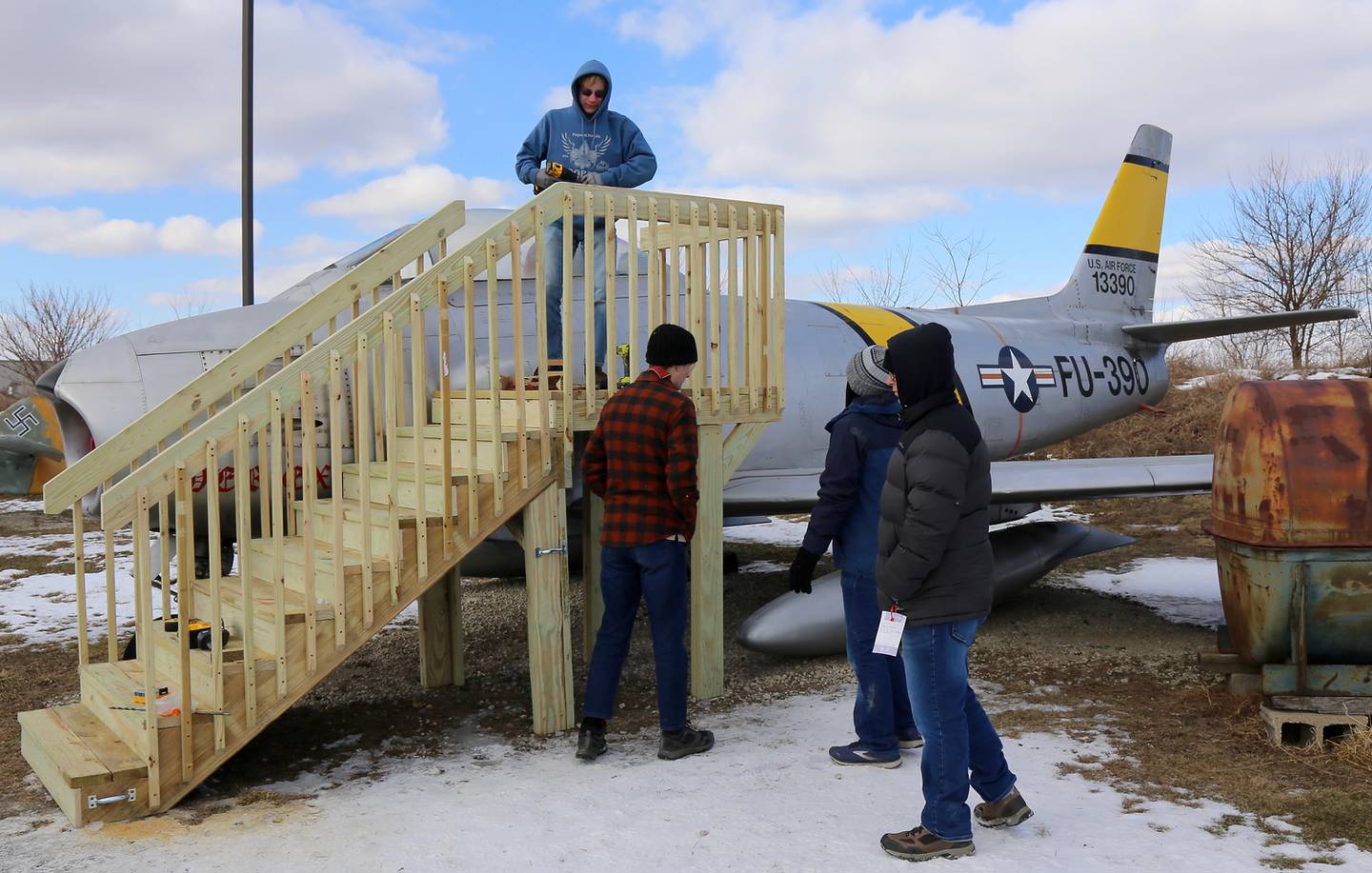 Logan Cunz finishes up installing stairs and an observation platform that is his Eagle Scout project at the Air Classics Museum in Sugar Grove on Sunday, Feb. 13, 2022.
