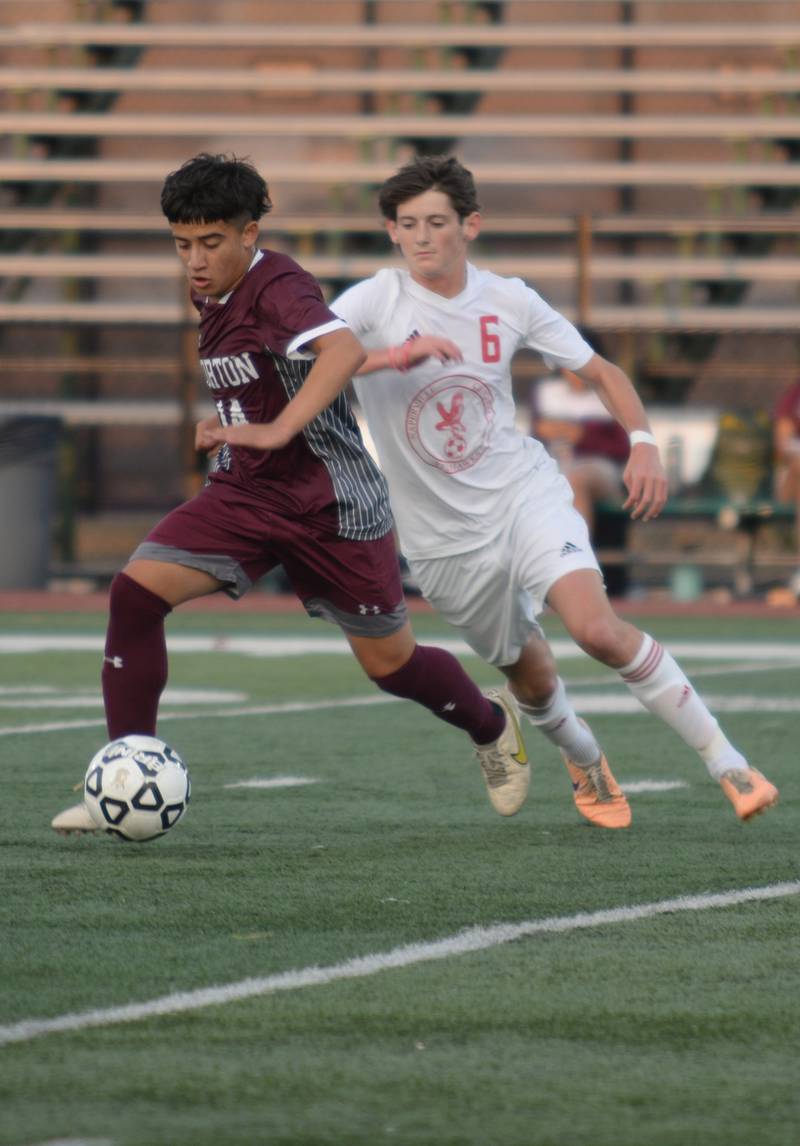 Morton West's Caleb Mendoza keeps the ball from t Naperville Central's Eli Jarrell during their home game in Berwyn Monday, Aug. 21, 2023.
