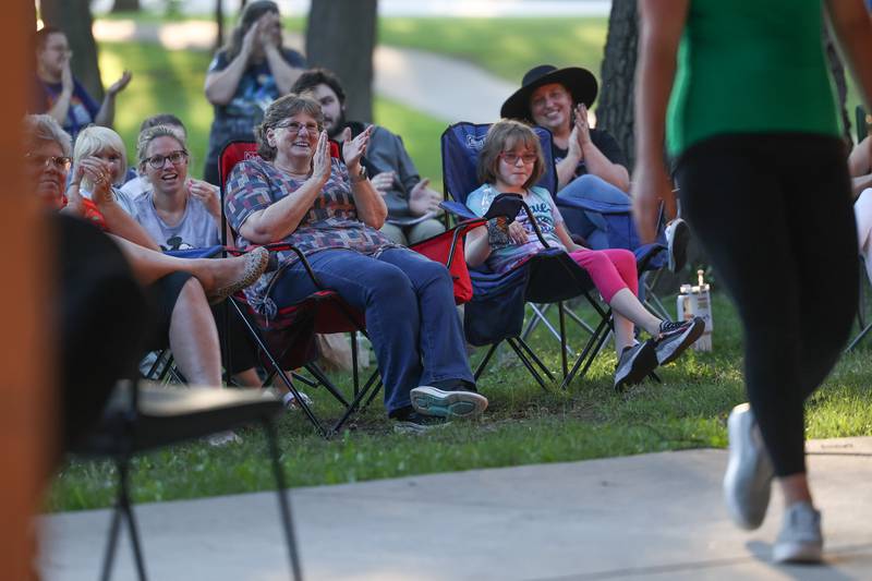 Beth Brooks, left center, and her granddaughter Sydney Murray, 10-years old, enjoy an improv scene at the GreenRoom Improv show hosted by the Morris Library at Goold Park on Friday, Aug. 11, 2023 in Morris.
