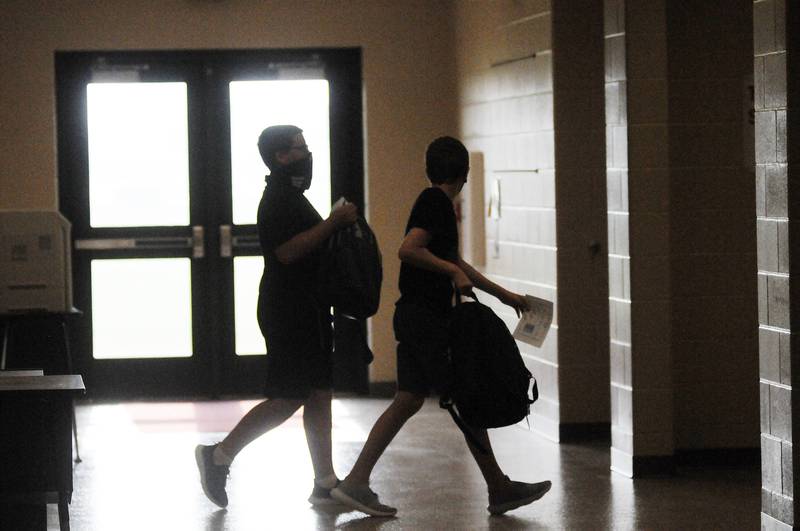 Students walk to their lockers on the first day of school at Grand Ridge Grade School on Wednesday, Aug. 18, 2021.
