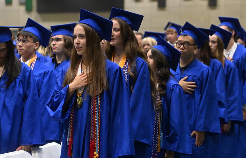 Wheaton North graduates sing the National Anthem during the commencement ceremony on Saturday, May 24, 2025 at College of DuPage in Glen Ellyn.