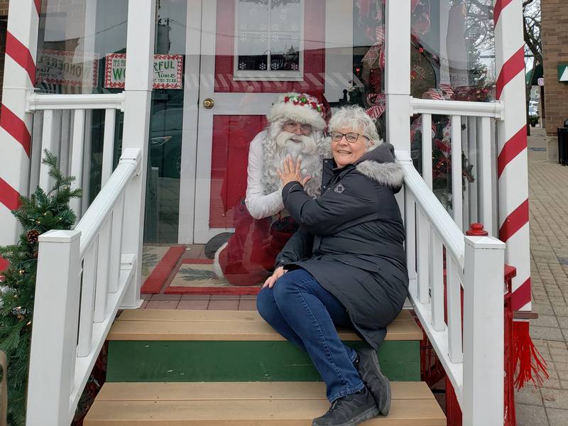 Downtown Crystal Lake Executive Director Diana Kenney in December 2021 with Santa Claus at the Santa House in downtown Crystal Lake. The annual visits are organized by the Downtown Crystal Lake nonprofit.