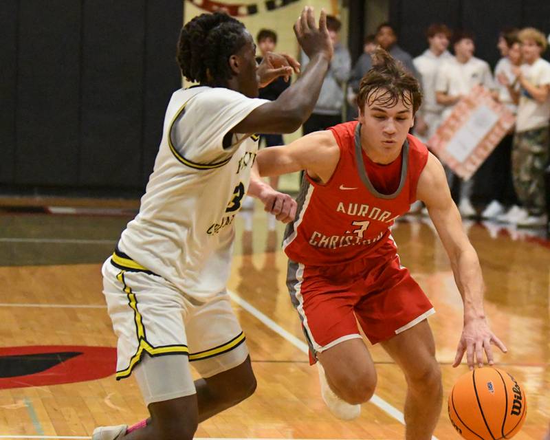 Aurora Christian's Preston Morel, right, dribble towards the basket while being defended by Yorkville Christian's Jayden Riley (3) during the regional title game on Friday Feb 28. 2025, held at Indian Creek High School.