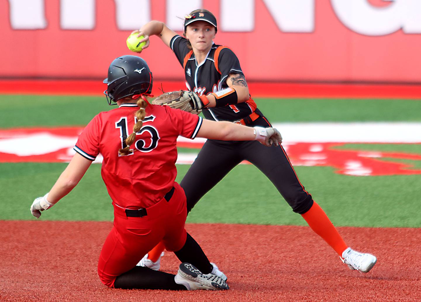 Huntley’s Isabella Boskey, left, is forced by DeKalb’s Hazel Montavon  at second base in IHSA Class 4A Sectional Semifinal softball action at Barrington High School in Barrington on Wednesday, June 4, 2025.