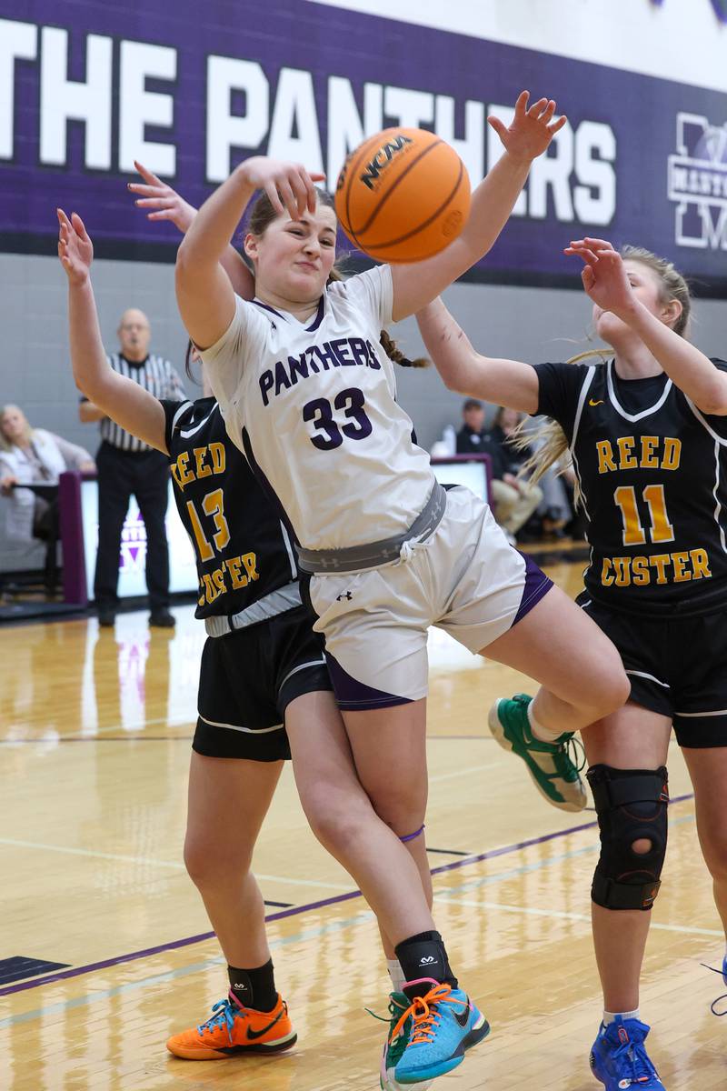 Manteno's Brooke Blanchette grabs for a rebound against Reed-Custer players during Reed-Custer's 45-42 victory over Manteno on Monday, Feb. 2, 2026.