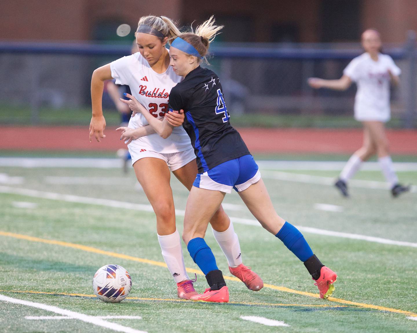 Batavia's Hannah Hickman battles for the ball with St. Charles North's Kaitlyn Nudera on Thursday April 11, 2024 in St. Charles.