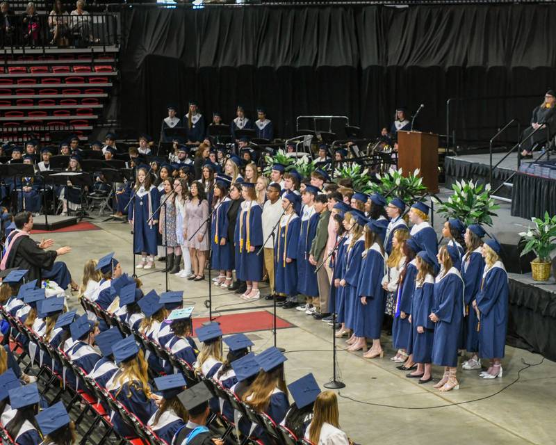 Oswego East’s choir preforms a song during the graduation ceremony on Saturday May 17, 2025, held at the Convocation Center in DeKalb.