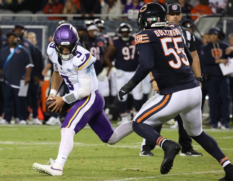 Minnesota Vikings quarterback J.J. McCarthy scrambles away from Chicago Bears defensive end Dayo Odeyingbo during their game Monday, Sept. 8, 2025, at Soldier Field in Chicago.