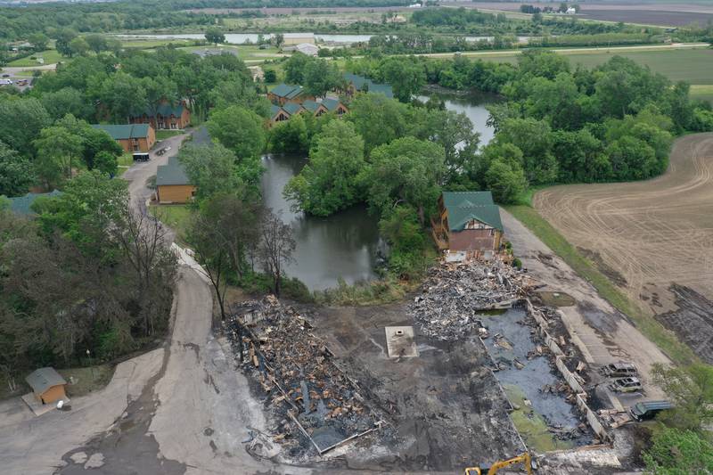 The foundations of three sets of cabins, dead trees, and burnt vehicles are all that remains after a major fire swept through the Grand Bear Resort and set fire to 28 cabins on Tuesday, May 31, 2022 in Utica.