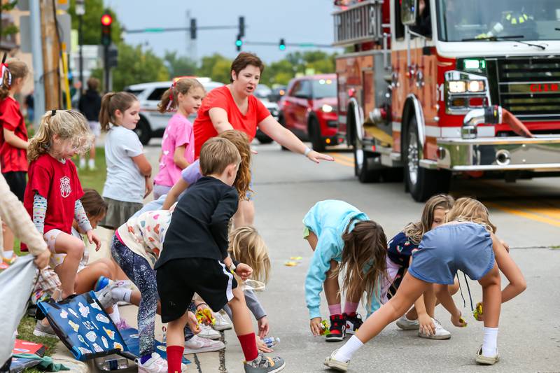 Kids gather candy at the Glenbard West Homecoming Parade.  Sept 16, 2023