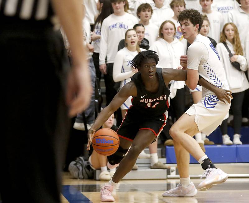 Huntley's Sheldon Bonsu drives the baseline agains Burlington Central's Myles Lowe during a Fox Valley Conference boys basketball game on Friday, Dec. 15, 2023, at Burlington Central High School.