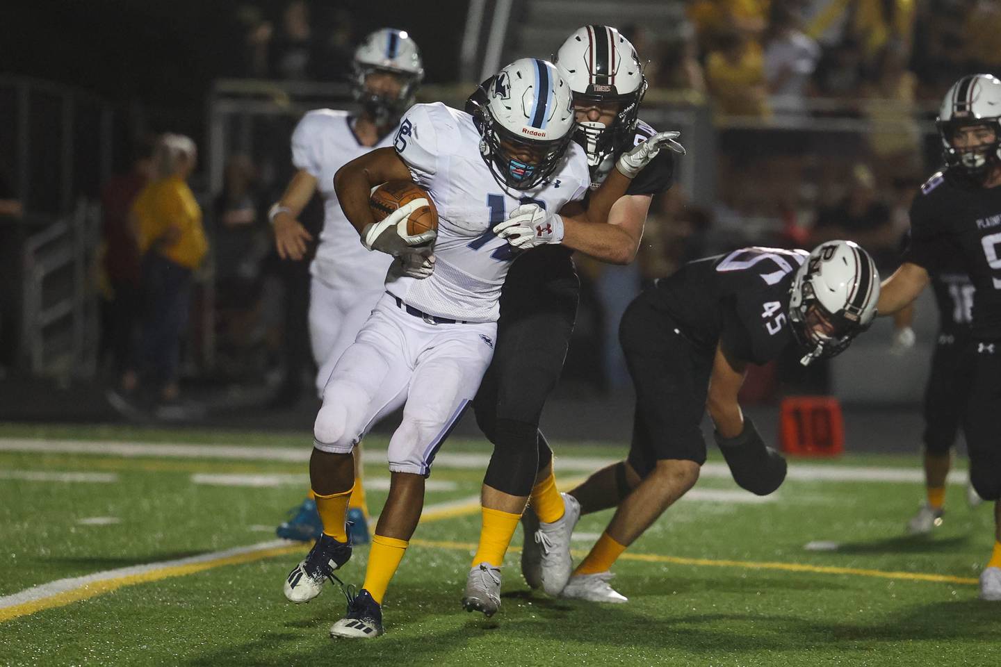 Plainfield North’s Logan Rooney wraps up Plainfield South’s Janusz Pierscionek for a loss. Thursday, Sept. 15, 2022, in Plainfield.