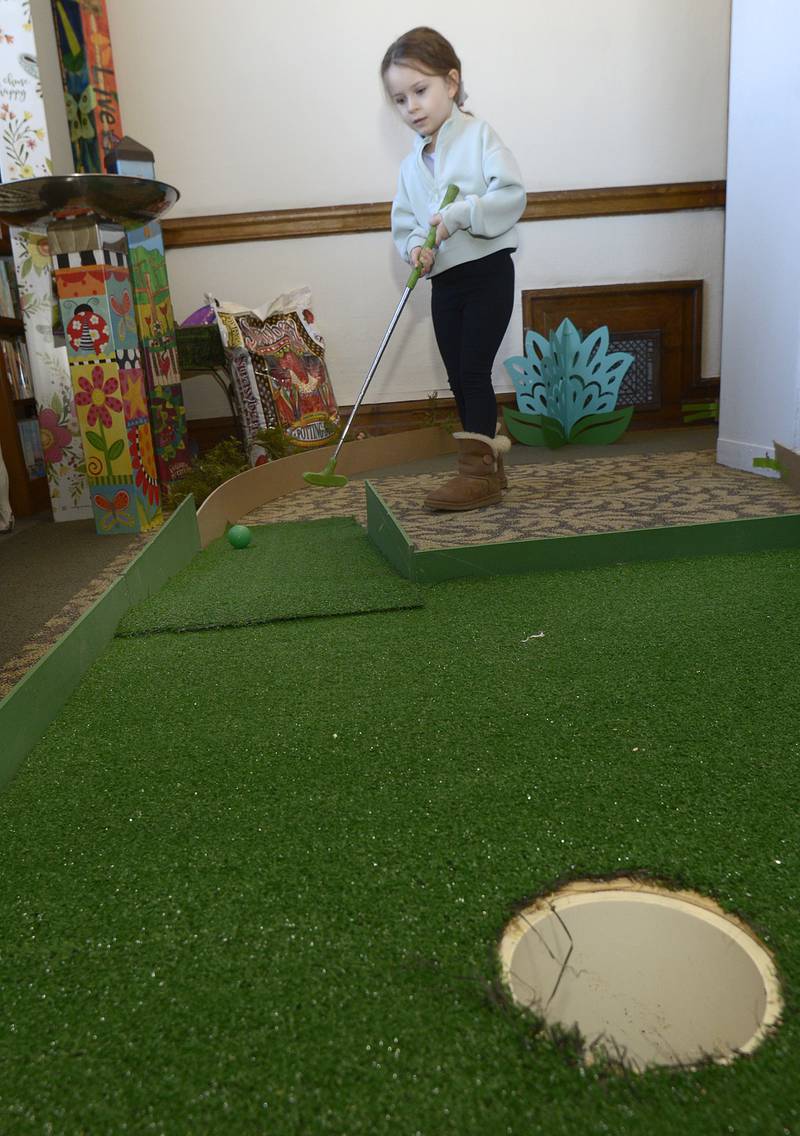 Hanna Schemer begins her approach to the 7th hole Saturday during the Carnegie Challenge Mini Golf FUN-Raiser at the Streator Public Library.