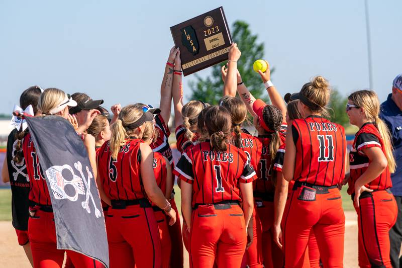 Yorkville players raise the 4A sectional championship plaque up in the air in celebration after defeating Wheaton Warrenville South for the sectional championship at Oswego High School on Friday, June 2, 2023.