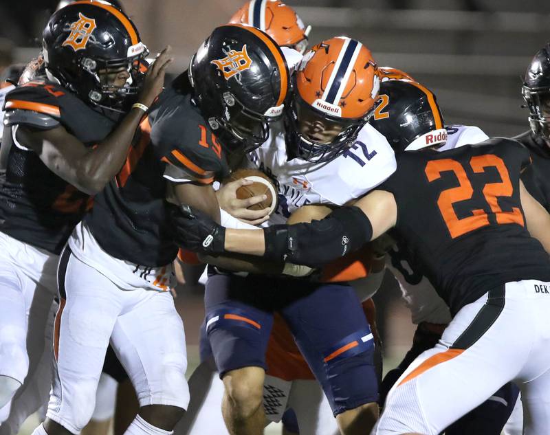 Naperville North quarterback Aidan Gray is swarmed by the DeKalb defense during their game Friday Sep. 25, 2021 at DeKalb High School.