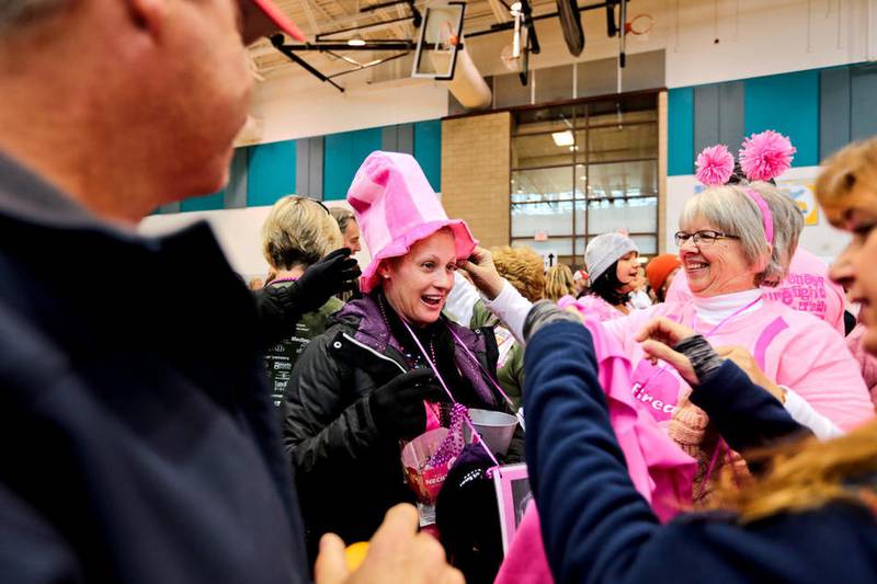 Lori Shivley of Crystal Lake receives a hat from her aunt Connie Seemann upon her arrival Oct. 18 at the Care4 Breast Cancer 5K Run/Walk in Woodstock,Ill. Shivley, who is undergoing radiation treatments for stage 3 breast cancer had close to 70 friends and relatives come to support her at the race.