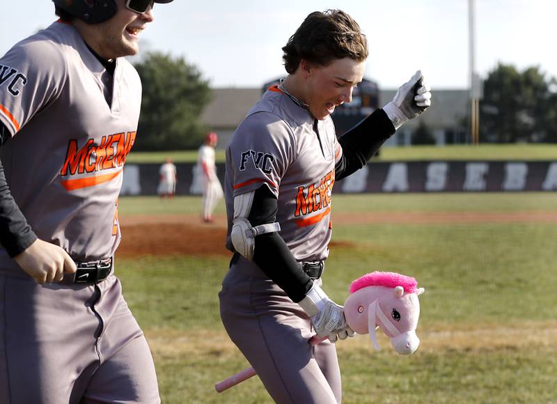 McHenry’s Carver Cohn celebrates his grand slam home run during a Fox Valley Conference baseball game against Huntley on Friday, April 11, 2025, at Huntley High School.