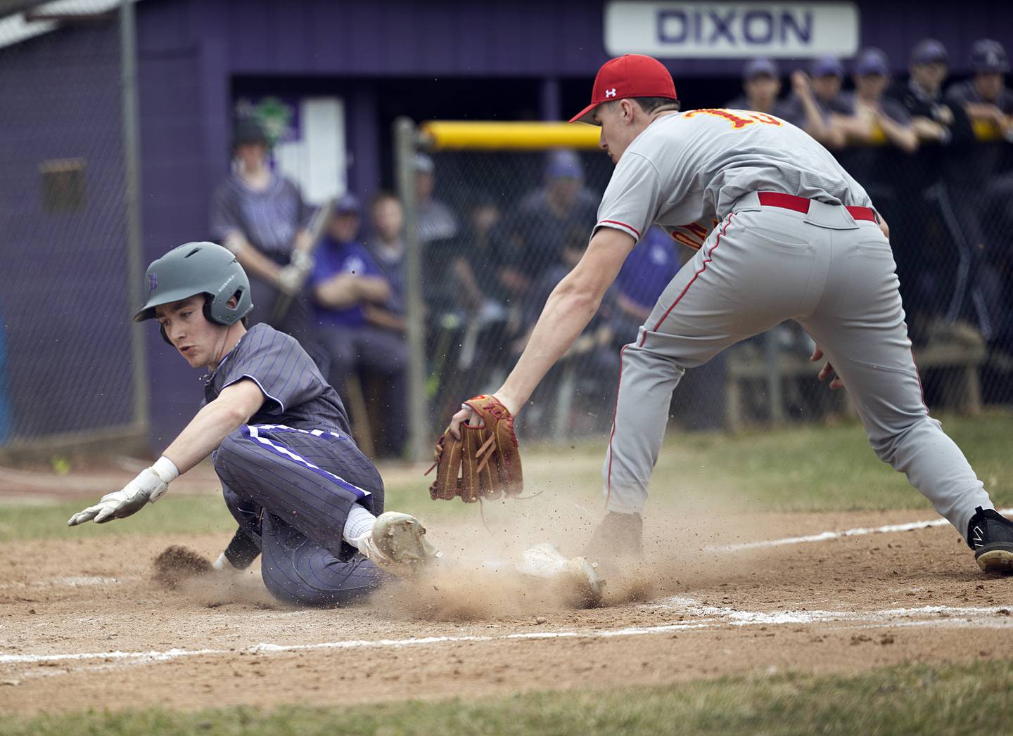 Dixon’s Quade Richards avoids a tag at home against Rockford Jefferson Wednesday, March 13, 2024. The Dukes scored three runs by stealing home in the first inning.
