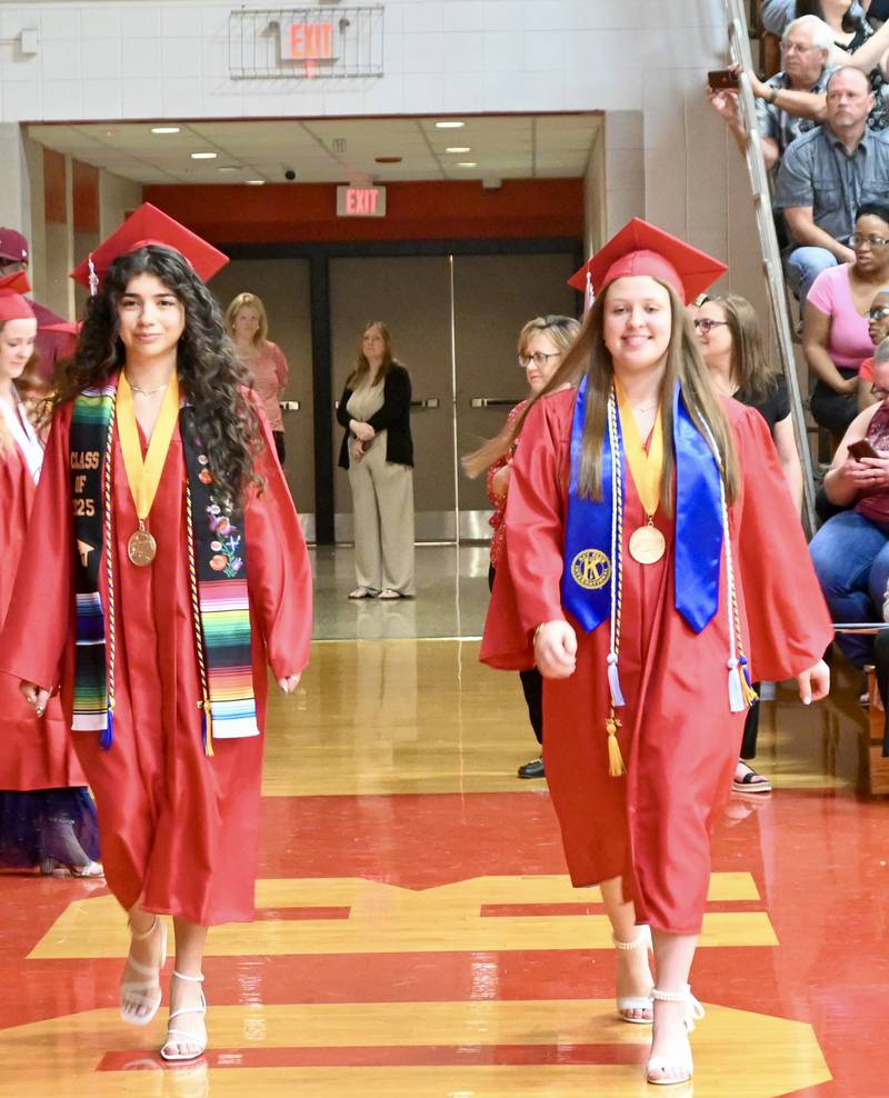 Indyana Hernandez and Leah Krohe walk during the Class of 2025 Commencement ceremony on Sunday, May 18, 2025 at Streator Township High School.