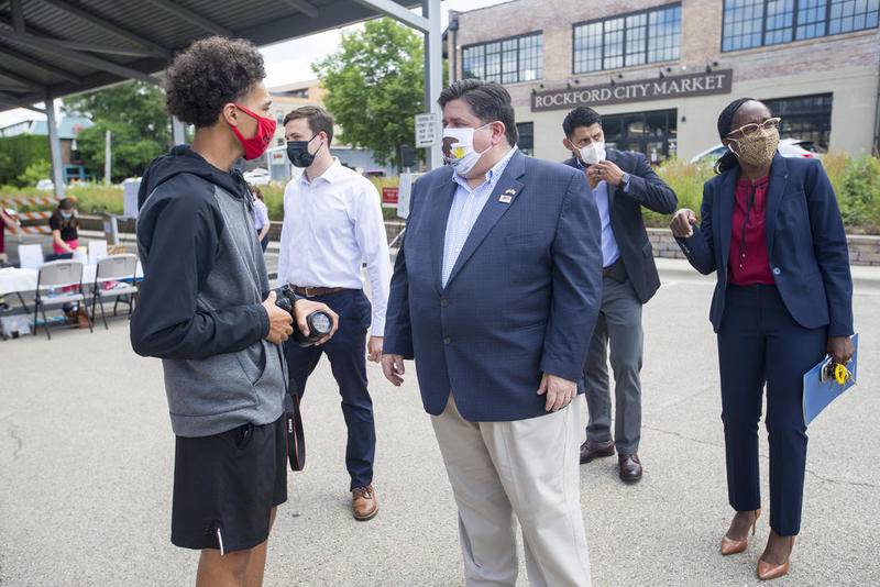Gov. JB Pritzker (right) greets videographer Tamir Bell (left) at City Market on July 16 in Rockford after Pritzker's visit to promote the 2020 Census.