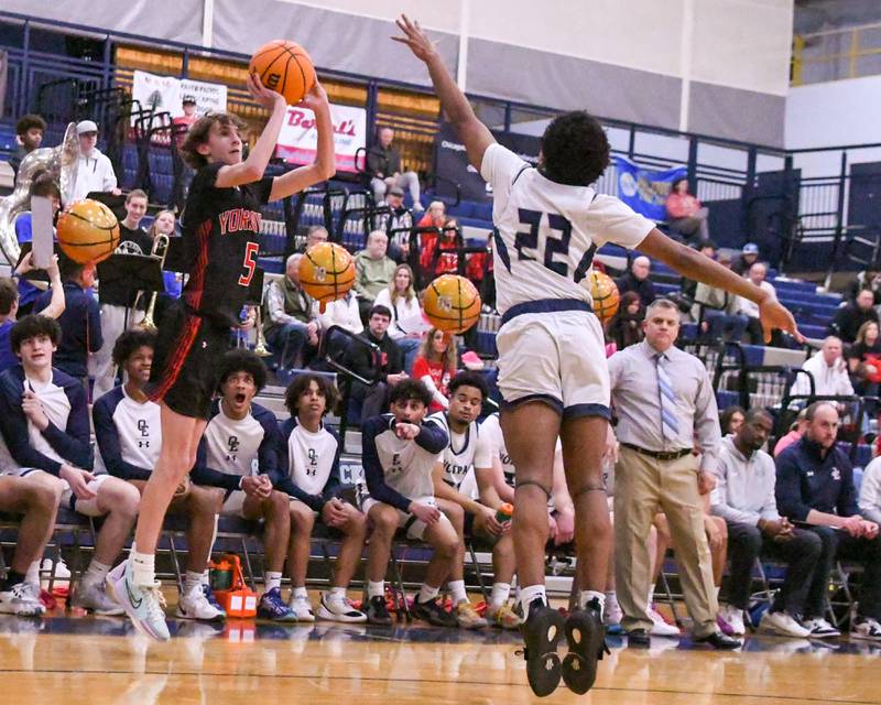 Yorkville's DJ Ingemunson (5) takes a shot during the game on Friday Feb. 14, 2025, while being defended by Oswego East's Morris Ellis (22) held at Oswego East High School.