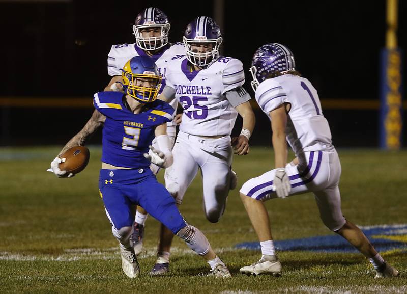 Johnsburg's Ian Boal tries to avoid Rochelle's Grant Gensler as he runs with the ball during a IHSA Class 4A second round playoff football game Friday, Nov. 4, 2022, between Johnsburg and Rochelle at Johnsburg High School in Johnsburg.