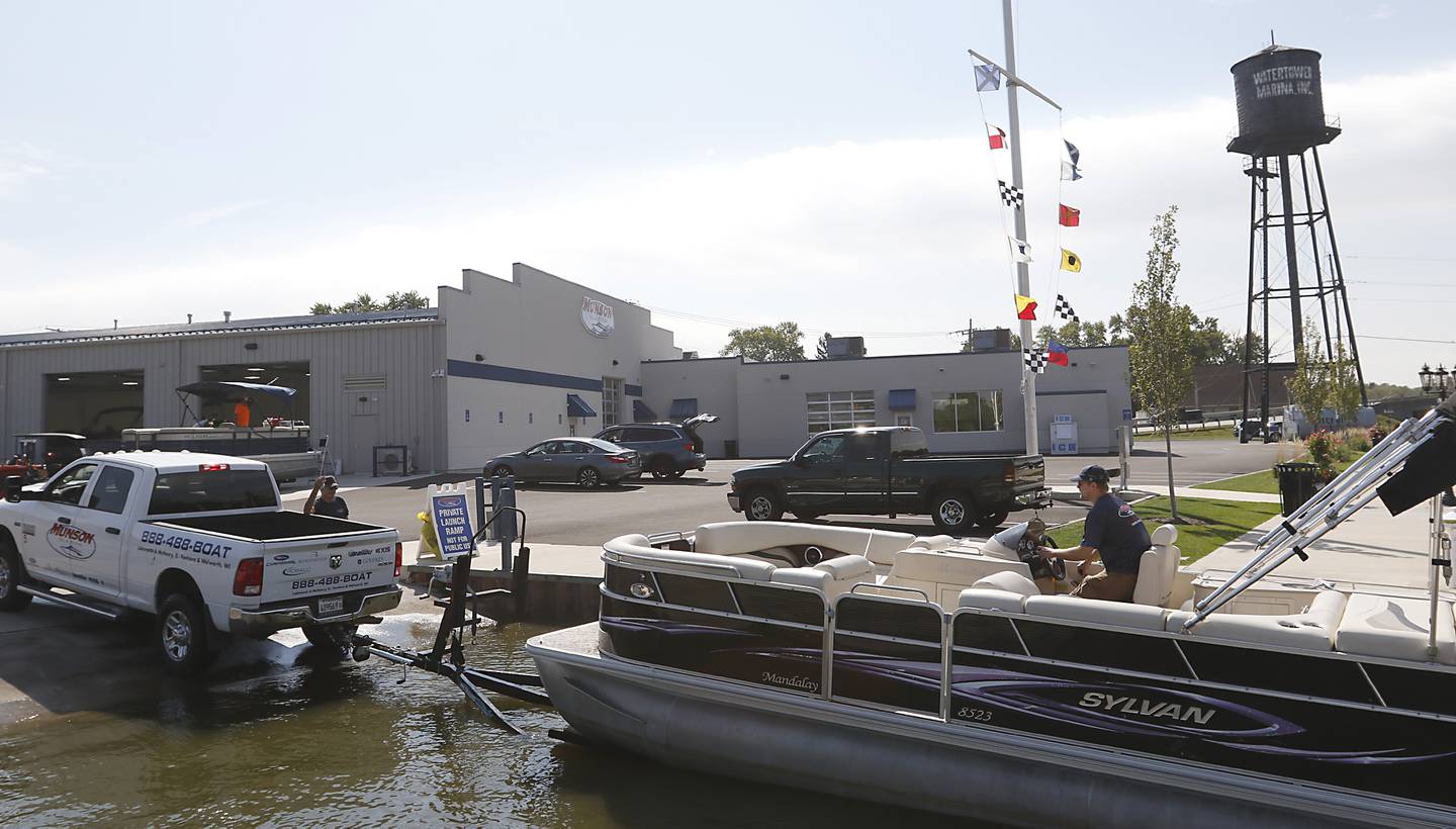 Technician Jarad Cooper loads a pontoon boat on a trailer  at Munson Marine, 3112 W. Lincoln Road, in McHenry, on Tuesday, Sept. 20, 2022. Munson Marine has brought the marina back to life after purchasing the derelict marina about two years ago.