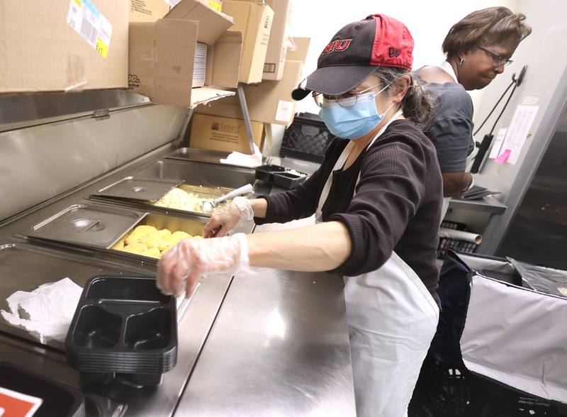 Fern Evins, a kitchen assistant at the Voluntary Action Center, prepares meals for delivery Thursday, Nov. 17, 2022, at the facility in Sycamore. VAC delivers meals to the home bound and elderly along with providing transportation options.