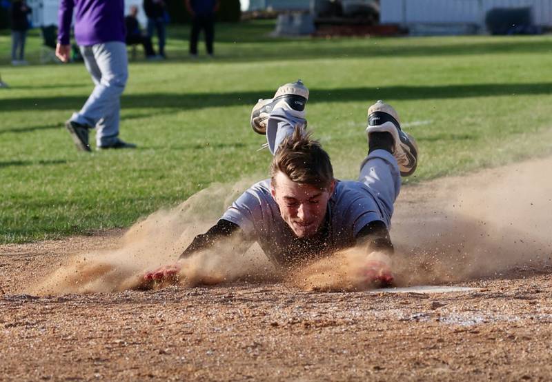 Mendota's Jack Gillespie slides in safely at home for the Trojans' second run of the seventh inning and game in a 6-2 loss at Princeton on Monday.