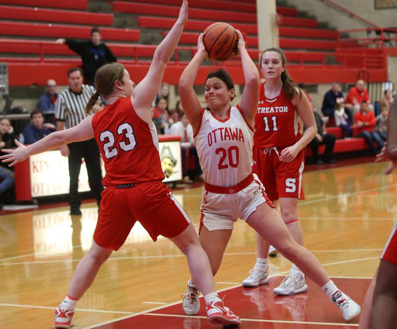 Ottawa's Kendall Lowery looks to pass the ball while making her way in the lane as Streator's Leah Krohe defends during the Lady Pirate Holiday Tournament on Wednesday, Dec. 20, 2023 in Kingman Gym.