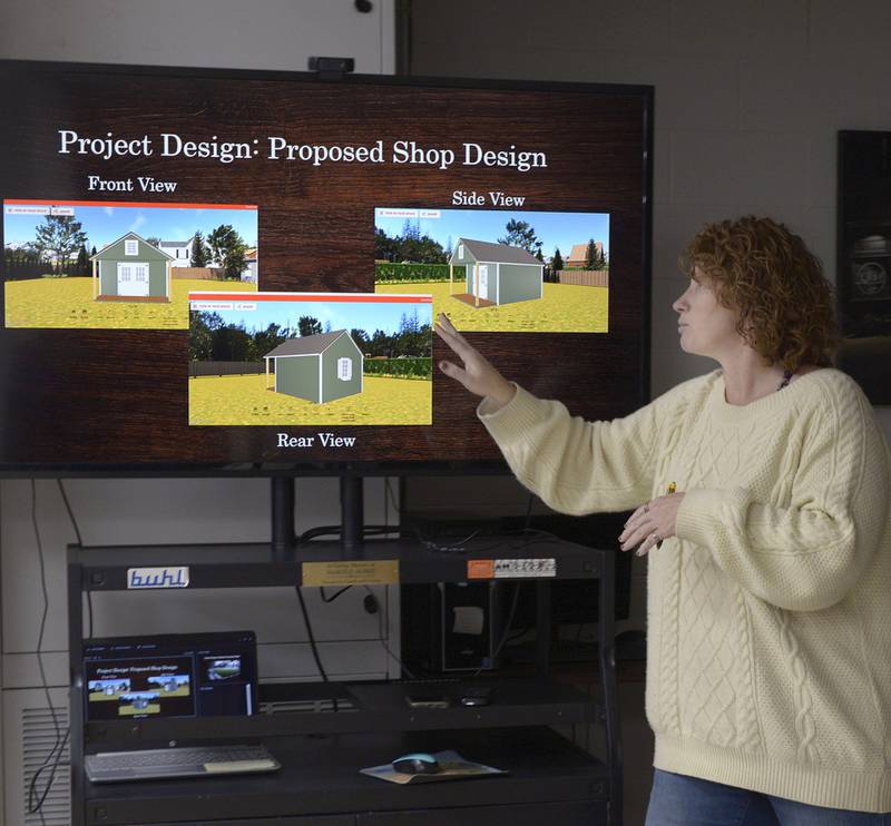 Jamie Turczyn, director of village affairs for Utica, shows a diagram of one of the portable retail stalls to be built at the Market on Mill, Utica's proposed outdoor retail plaza, during a meeting of the Utica Village Board on Wednesday, Nov. 15, 2023. Utica envisions 12 such stalls at the plaza, loosely targeted for opening in summer 2024.