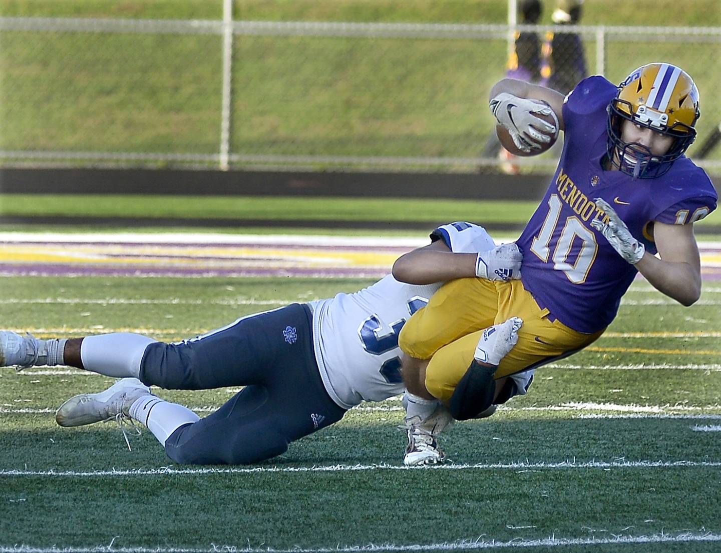 Newman Central’s Gabe Padilla tackles Mendota’s Uziel Angulo on a run in the 1st quarter Saturday at Mendota on Oct 16,2021.