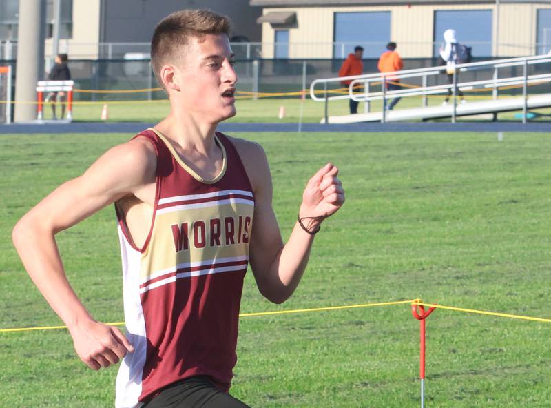 Morris's Everett Swanson runs toward the finish line of the 3200-meter run during the Class 2A Sectional on Wednesday, May 20, 2026 at Pontiac High School.