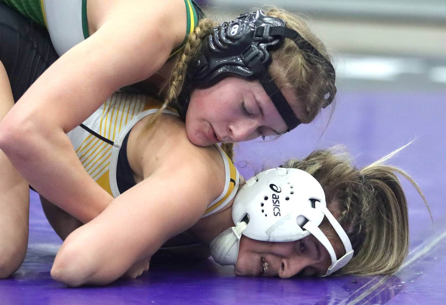 Crystal Lake South’s Annalee Aarseth, top, battles Harvard’s Alexa Herrera at 110 pounds in IHSA Regional wrestling semifinal action on Saturday, Feb. 1, 2025, at  Hampshire High School  in Hampshire.